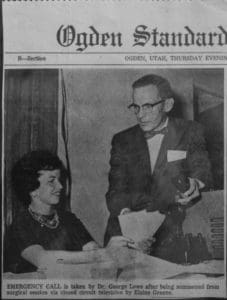 A man and woman are sitting at a table.