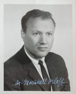 A black and white photo of a man in suit