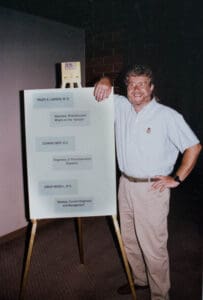 A man standing next to a flip chart