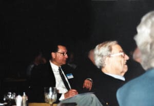 Two men sitting at a table with drinks.
