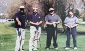 A group of men standing on top of a green.