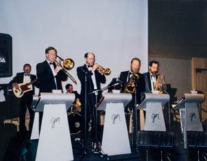 A group of men in suits playing instruments.