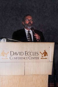 A man standing at the front of a podium speaking.