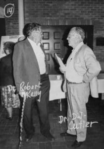Two men standing next to each other in a room.