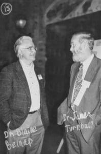 Two men are talking to each other in a room.