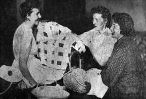 A group of people sitting around each other.