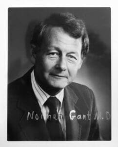 A black and white photo of a man in suit