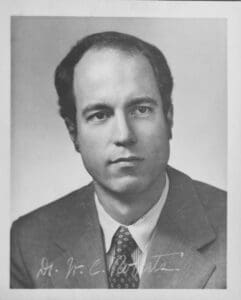 A black and white photo of a man in suit