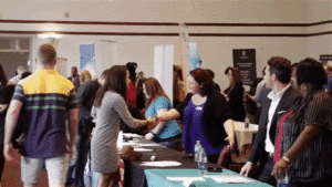 A group of people shaking hands at an event.