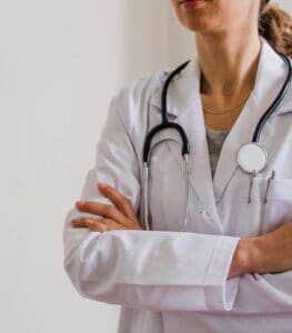 A woman in white lab coat with stethoscope.