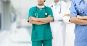 Two doctors standing next to each other in a hospital.