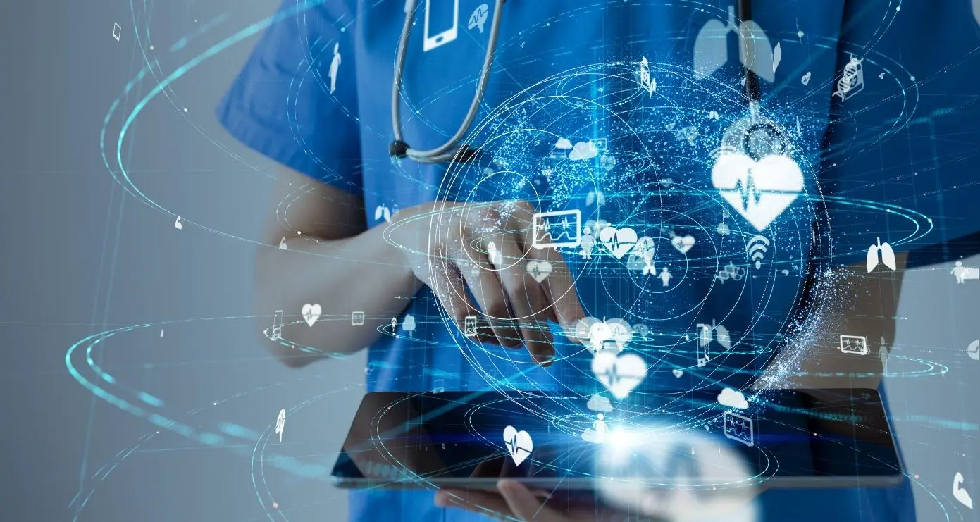 A doctor is using his tablet computer to work on the medical information.